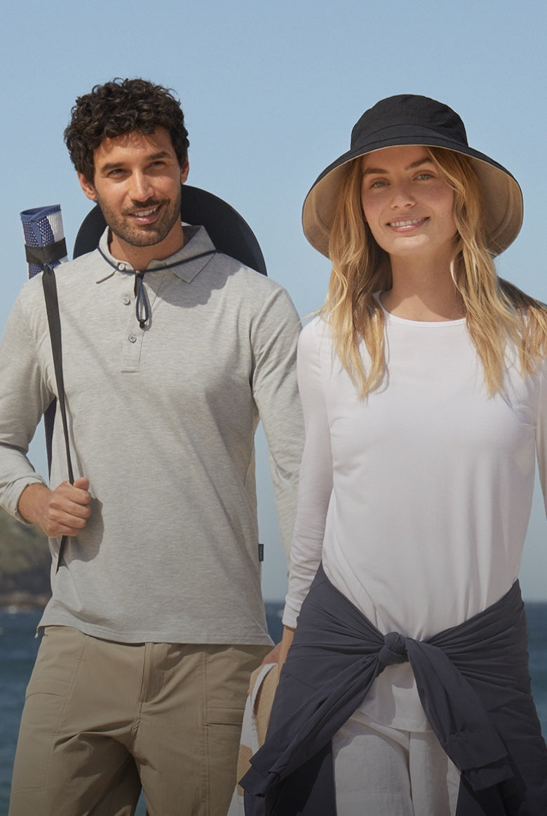 A man and woman wearing Solbari UPF 50+ clothing with the se behind them.