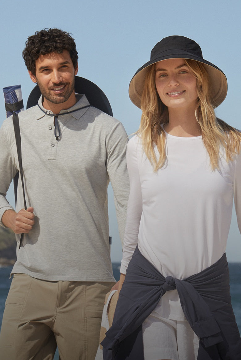Woman and man in sun smart clothing with blue sky behind them.