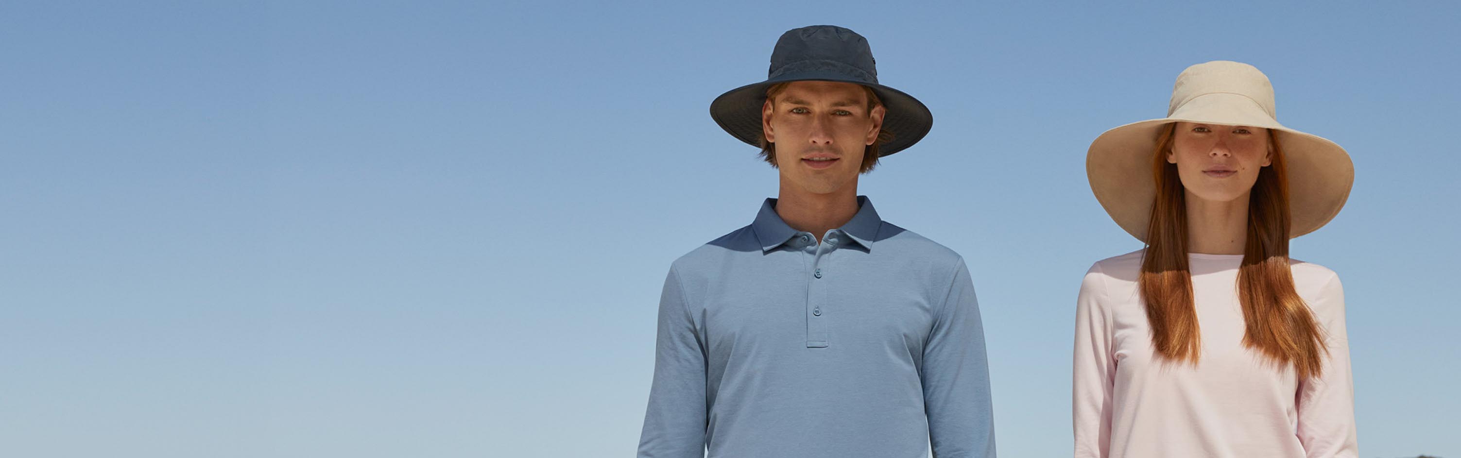 A man and a woman with a blue sky background behind them.