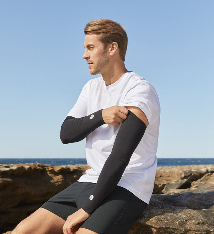 Man wearing UPF 50 clothing and arm sleeves.