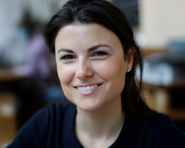 A woman in a black t-shirt with dark hair.