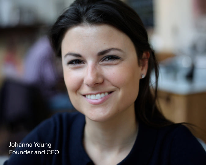 A woman, Johanna Young, with a warm smile, and a blurred background.