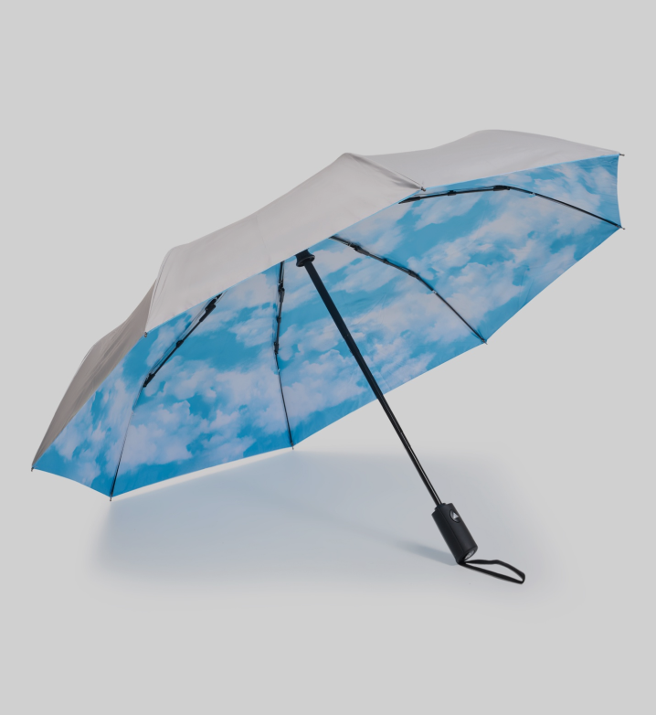 A sun umbrella with blue clouds and sky pattern on the inner side.