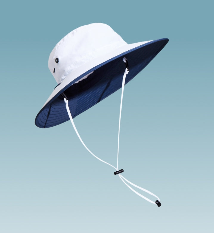 A white sun hat with a chin cord  floating on a light blue background.