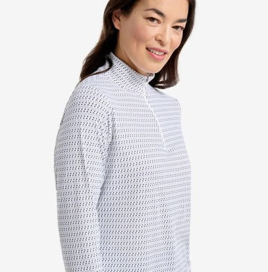 A woman wearing a zip top with golf flags print.