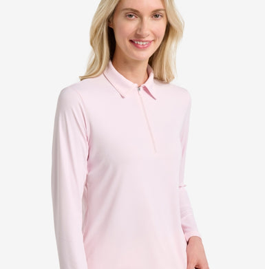 Pink zip up polo top on a woman.