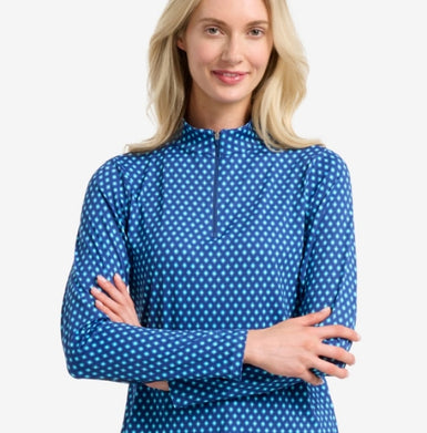 A woman in a diamond printed blue long sleeve top.