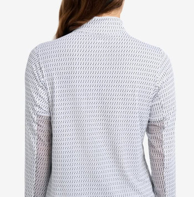 The back view of a woman wearing a printed top with long sleeves.