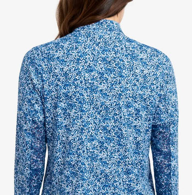 The back of a woman in a printed blue top.