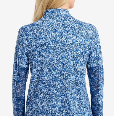 The back view of a top on a woman showing mesh printed sleeves.