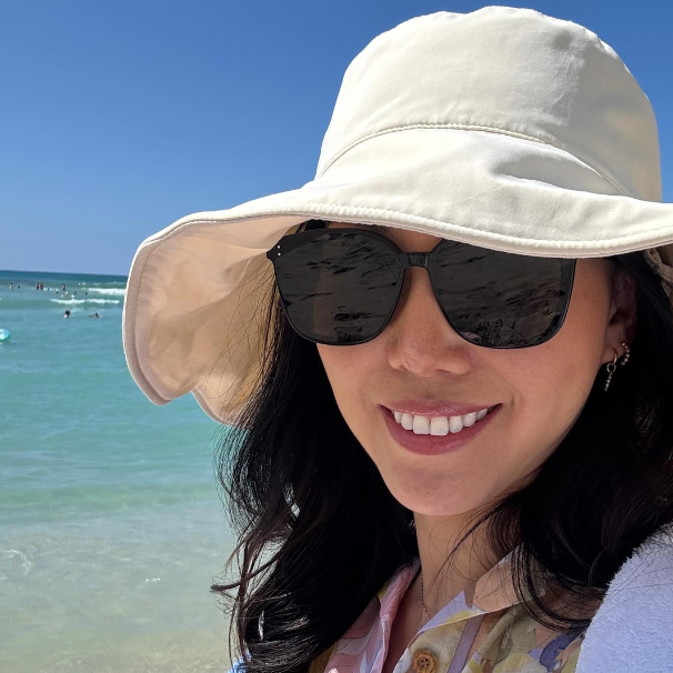 Woman in sunglasses wearing a Solbari sun hat