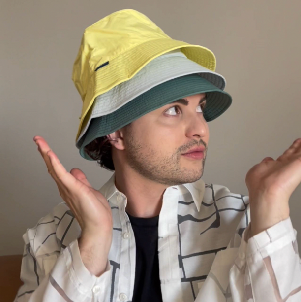 A man wearing three Solbari UPF 50 hats piled on his head