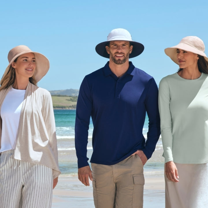 An image of three people walking on the beach in Solbari UPF 50+ sun protective clothing.