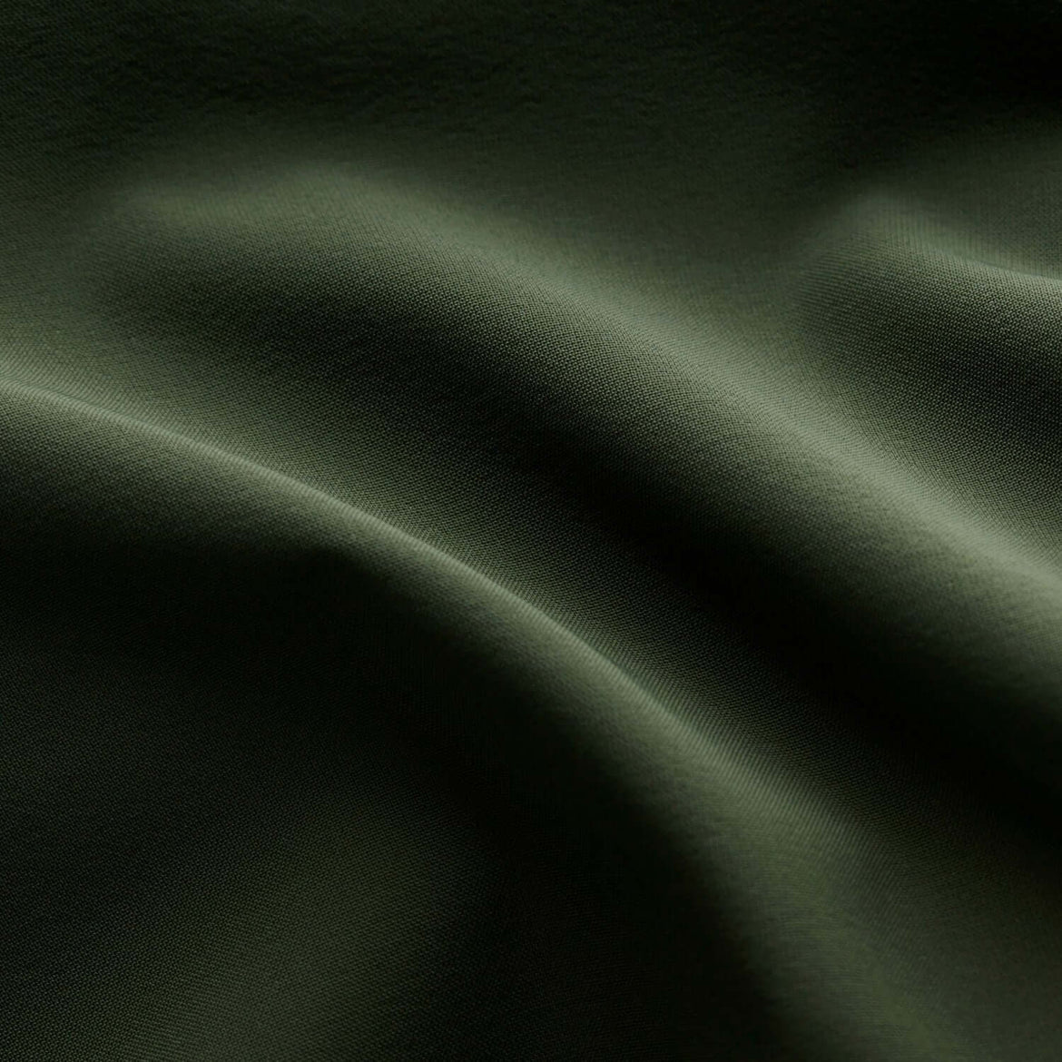 Green fabric close-up image.